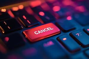 Red glowing cancel key on a backlit keyboard is stopping a process photo