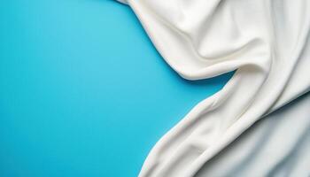 Elegant White Fabric Draped Over Blue Background with Copyspace for Creative Designs photo