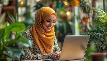 Empowered Muslim Businesswoman Working on Laptop Cozy Cafe Setting Inspirational Background Copyspace photo