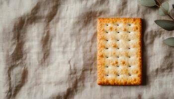 Crispy Cracker on Textured Linen Cloth Food Photography Background with Copyspace photo
