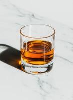 Whiskey Tumbler on Marble Background Low Resolution Copyspace for Content Creation photo