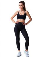 Confident Woman in Black Activewear Studio Background Full Body Portrait Copyspace Available photo
