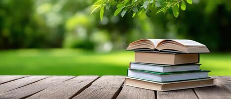 Open Books on Wooden Picnic Table in Nature Background Copyspace for Content photo