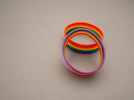 Top view of rainbow patterned wristbands is on a gray background photo