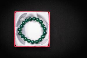 Jade bangle or bracelet in a red box on a black background photo