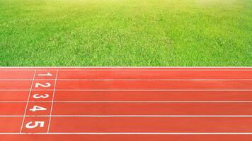 The running track in the red stadium is empty. photo