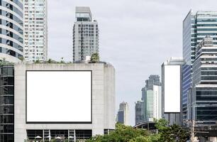 Two white mock up horizontal and vertical large LED display billboard on tower building. Clipping path for mockup photo