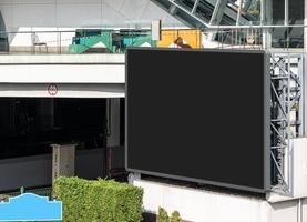 Mock up black screen LED display billboard at crossroad. Clipping path for mockup photo