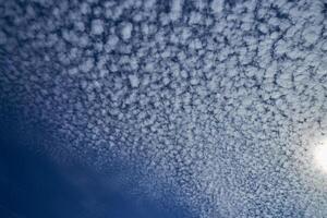 Sun shining through the puffy clouds. Sky view. Beautiful sunny sky. Background with clouds on blue sky. Clouds on blue sky. photo