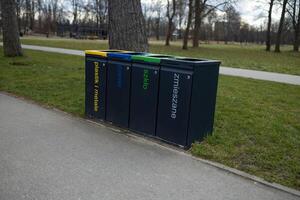 Trash Bins for Recycling in the Park, Different Containers for Waste Sorting photo