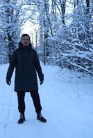 A beautiful and serene snowy landscape featuring a person dressed in a warm winter coat photo