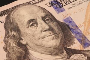 A detailed closeup view of a portrait depicting Benjamin Franklin on a Hundred Dollar Bill photo