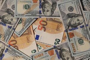 A visually captivating array of diverse currency notes featuring a mixed background of USD and Euro photo