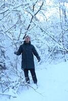A person enjoying a Winter Wonderland experience, surrounded by beautiful snowy trees photo