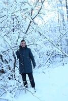 A person stands peacefully in a stunning snowy winter wonderland filled with tranquility photo