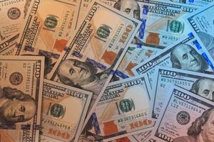 Numerous Stacks of U.S. Dollar Bills Neatly Arranged on a Table Surface for Display photo