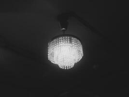 An Elegant Chandelier Gracefully Illuminating a Dark Space with Sophisticated Ambiance photo