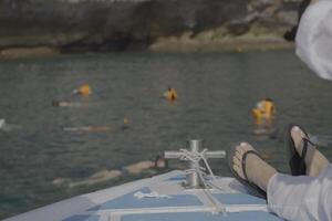Enjoy a soothing and relaxing boat trip with swimmers in the clear, inviting waters photo