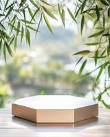 Hexagonal white podium with bamboo leaves photo