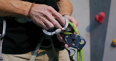 A person is holding a climbing rope and using a carabineer photo