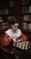 A woman playing chess photo