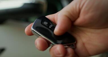 A person holding a remote control in their hand photo
