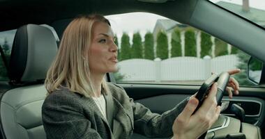 A woman in a car using a cell phone photo