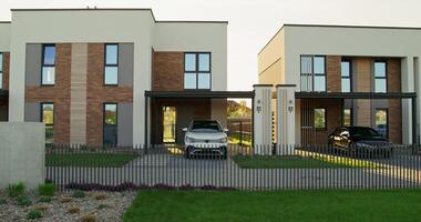 A modern house with a car parked in front photo