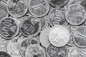Indonesian Rupiah Coins Close-Up. Pile of Indonesian 1000 Rupiah Coins. Stack of penny coins photo