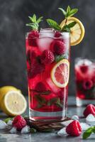 A refreshing raspberry lemonade drink garnished with mint and lemon slices. photo