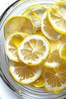 A close-up of fresh lemon slices in water, showcasing their vibrant color and texture. photo
