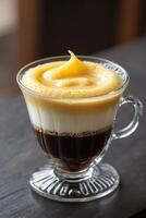 A visually appealing coffee beverage with layered textures and creamy topping. photo