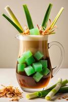 A refreshing beverage in a pitcher, featuring green jelly cubes and garnished with herbs. photo