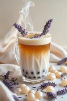 A visually appealing drink with layers of tea and milk, garnished with lavender and decorative elements. photo