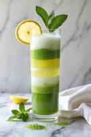 A vibrant layered drink with lemon and mint, showcasing a refreshing beverage presentation. photo