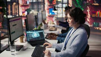 Call center worker using artificial intelligence customer service management software. Customer service agent using AI technology to log customer interactions in CSM system, camera B video