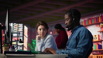 Call center manager supervising agent providing step by step guidance to customers. Customer center supervisor overseeing work done by employee walking clients through technical solutions, camera B video