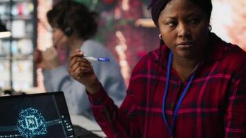 Call center agents using artificial intelligence tech to provide step by step guidance to customers. Customer center coworkers using AI technology to walk clients through technical solutions, camera A video