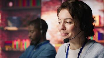 Customer support workers doing upselling, recommending products to clients during conversation. Call center agents contact prospects to inform them about new services and promotions, camera A close up video
