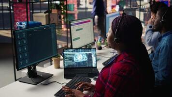Call center employee using AI chatbot at office desk to reply to common customer queries, close up. Customer service staff member at work generates automated responses to clients using AI, camera B video