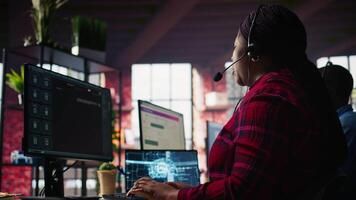 Call center worker in office using AI chatbot to provide quick replies to common customer queries. Woman doing customer service job generating automated responses to clients using AI, camera B video