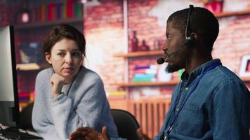 Call center manager supervising agent providing step by step guidance to customers. Customer center supervisor overseeing work done by employee walking clients through technical solutions, camera A video