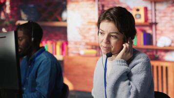 Call center agent helping customers regain access to accounts, resetting passwords. Employee in customer center workspace assisting clients needing help, providing helpful solutions, camera A video