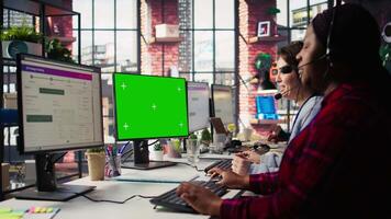 Call center agent providing live chat support using green screen PC, handling clients complaints. Employee using chroma key computer, dealing with unsatisfied customers, camera B close up video