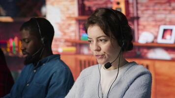 Customer support workers assisting clients to meet outbound call quotas and sales targets. Call center agents contacting prospects to inform them about new products, camera A video