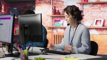 Worker providing live chat support, typing on keyboard, handling clients complaints. Call center agent dealing with unsatisfied customers, providing helpful solutions to their concerns, camera A video