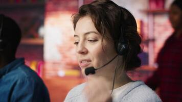 Call center employee handling customer inquiries, complaints and support requests in office. Customer service representative assisting customers with issues related to products or services, camera A video