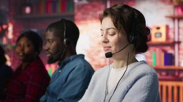 Friendly customer support workers respond to customers inquiries about products or services. Cheerful call center agent in office providing accurate and satisfactory information to customers, camera A video