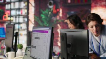 Call center manager teaching intern how to track clients shipment parcels. Customer center team leader doing induction to trainee, locating clients packages and providing status updates, camera A video