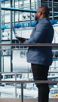 Vertical Photovoltaics smart factory investor analyzing data and talking with engineers before deciding to invest. Industry 4.0 solar panels plant shareholder discussing business plan with workers, camera A video
